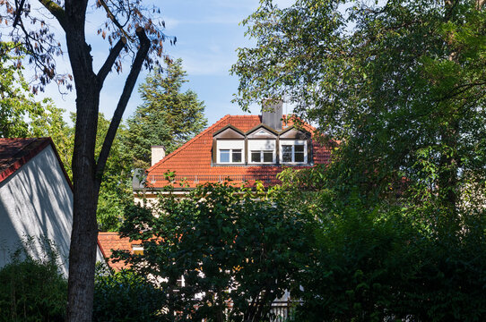Residential House with Orange Roof Among Green Trees