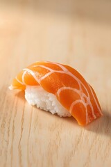 Fresh handcrafted salmon nigiri sushi presented on a clean wooden surface with soft lighting, showcasing premium fish texture and minimalist Japanese cuisine aesthetic