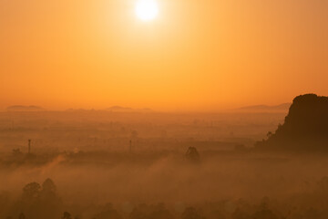 Obraz premium Aerial view of golden morning light and mountains.