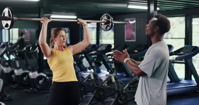 Barbell, personal trainer and training with woman in gym for weightlifting, fitness and muscle workout. Intense challenge, coaching and bodybuilder exercise with people for powerlifter athlete