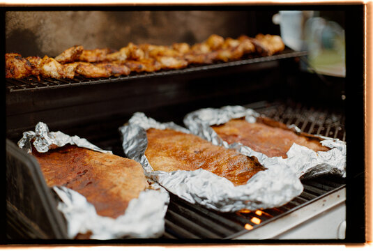 Grilling Pork Ribs and Chicken on the Barbecue for a Summer Gathering