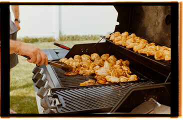 Grilling Chicken Wings at a Backyard Barbecue in Summer