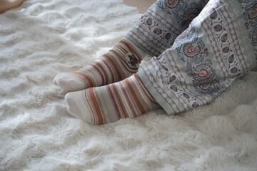 Cozy socks on a soft rug in a relaxed bedroom setting