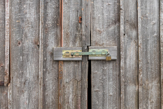 Weathered Wooden Door with Latch and Padlock