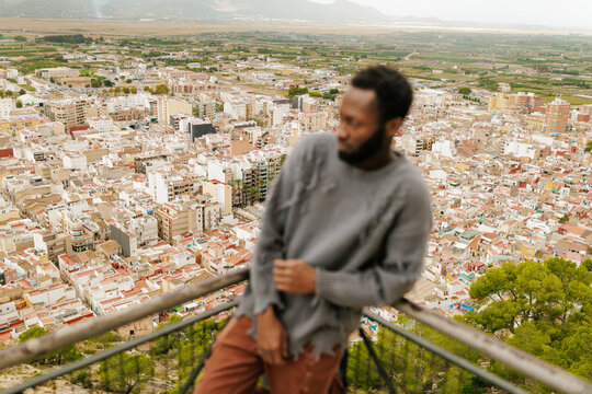 Man observing a city landscape from viewpoint