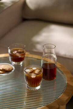 Refreshing iced coffee served on a stylish table with cookies