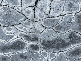 road surface with chemical reactants for removal during winter of ice on asphalt.