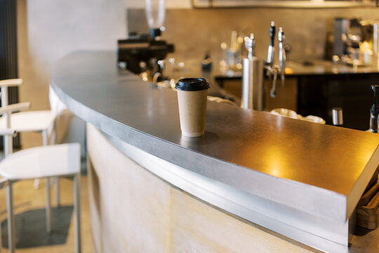 Coffee Cup on Bar Counter in Modern Cafe Setting in the Afternoon