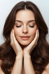 Relaxed young woman with glowing skin gently touching her face while enjoying a calm skincare moment against a clean soft beauty background