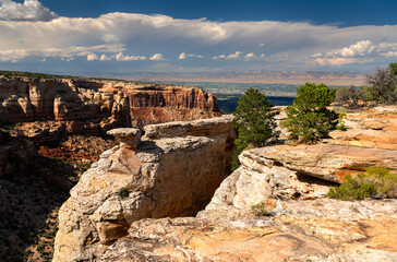 View from Cold Shivers Point Overlook in Colorado National Monument. White sandstone is in the foreground, with Columbus Canyon and the Grand Valley below