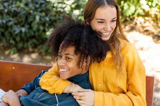 Young couple sitting on bench relaxing and laughing 