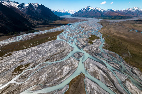 Aerial of braided river and mountain range in New Zealand. 