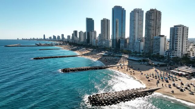 Aerial view of a modern city skyline along a sunny beach with turquoise water and rock breakwaters vector illustration
