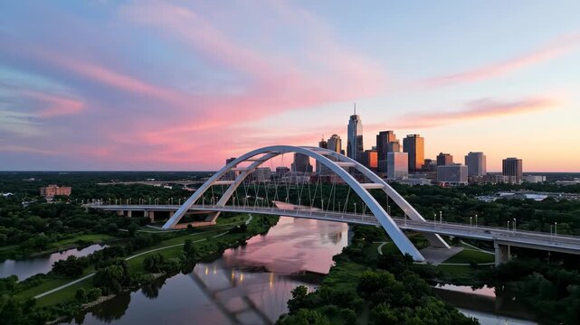 Aerial view of the distinctive white arch bridge over a river with the downtown city skyline at sunset vector illustration