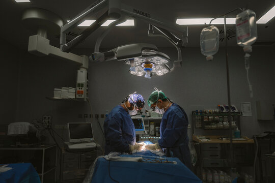 Surgeons performing delicate medical operation in operating room
