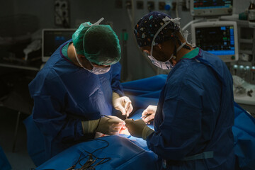 Surgeons performing delicate surgical procedure in operating room