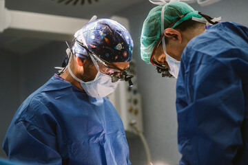 Surgeons performing complex surgery in operating room