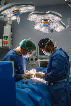Surgeons performing delicate medical procedure in operating room