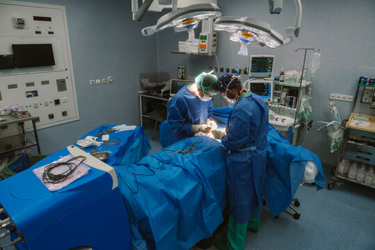 Surgeons performing live surgery in operating room