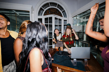 Group of friends celebrating music at a house party