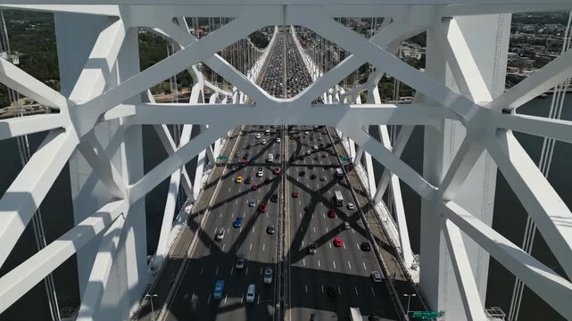 Aerial view looking down through the white truss structure of a suspension bridge with heavy traffic below vector illustration