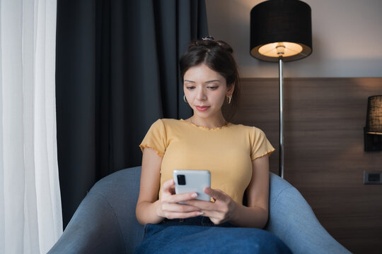 Young Hispanic American Gen Z Woman Using Smartphone in Modern Technology Concept