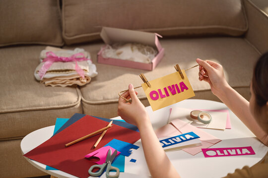 Crafting a personalized name card for Olivia with colorful paper