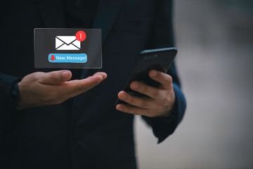 Businessman touching new message notification icon on virtual screen,email alert, online messaging system, representing digital communication, instant response, and business connectivity.