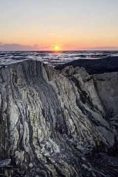 Beautiful orange sunset and gradient sky over ocean waves