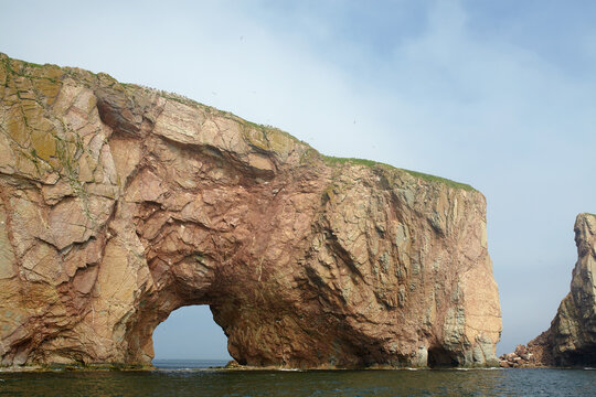Perc&eacute; Rock natural formation cliff with a hole at the bottom