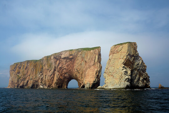 Perc&eacute; Rock natural formation cliff with a hole at the bottom