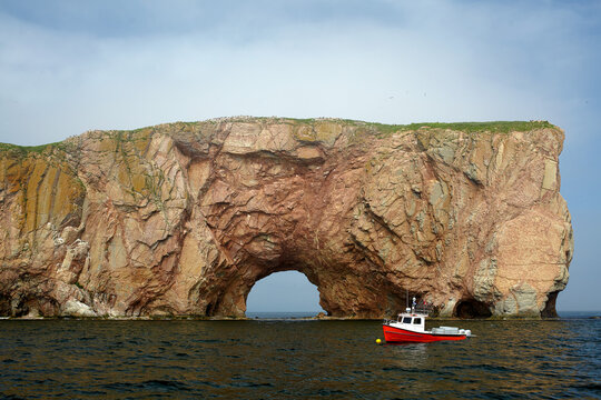 Perc&eacute; Rock natural formation cliff with a hole at the bottom