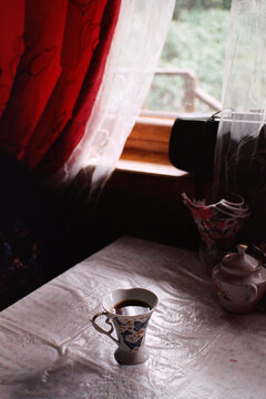 Enjoying a Warm Tea by the Window on a Cozy Day