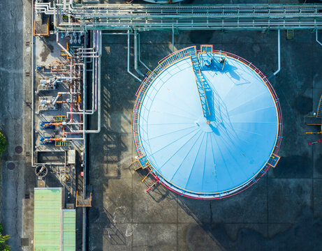 Aerial View of Blue Industrial Storage Tank with Pipelines