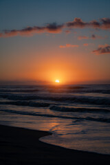 Vibrant Orange Sunrise over the Atlantic Ocean Waves with Wet Sand and Reflection at Emerald Isle, North Carolina Beach
