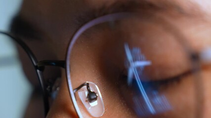 A person wearing glasses works on a laptop, with a glowing digital wind turbine reflected in the lens. A highlights themes of renewable energy, sustainability, clean technology, and modern innovation. - Powered by Adobe