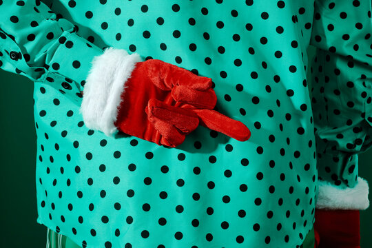 man giving a middle finger wearing red velvet gloves with white trim
