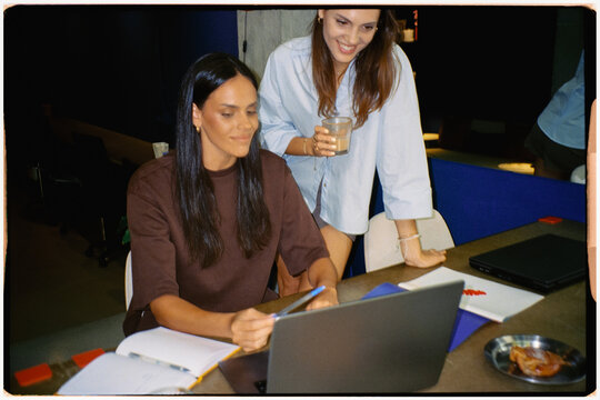 Analog shot of two female colleagues working together