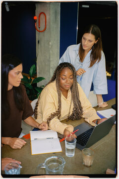 Analog shot of a team of empowered women collaborating