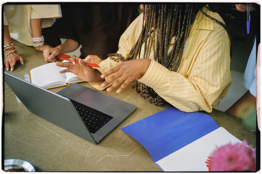 Unidentified Black woman working on a laptop