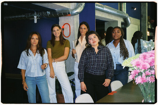 Analog portrait of a group of female professionals posing and smiling