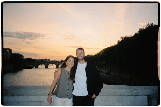 Analog portrait of a couple on vacation on a bridge over Seine River