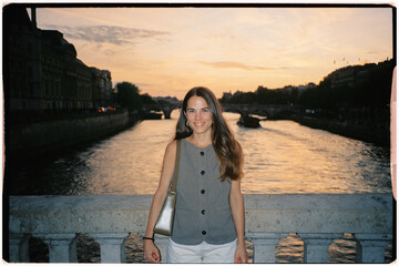 Analog portrait lit with flash of a tourist posing by the Seine River