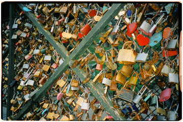 Metal fence covered with weathered padlocks