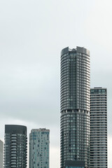 Fototapeta premium Urban skyline with modern glass residential skyscrapers reaching for the sky