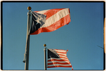 Flags of Puerto Rico and the United States waving in the breeze