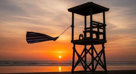 Lifeguard tower silhouette on sandy beach with waving flag at breathtaking sunset coastal horizon