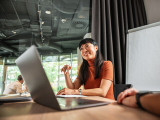 Confident Woman Leads a Meeting With Laptop
