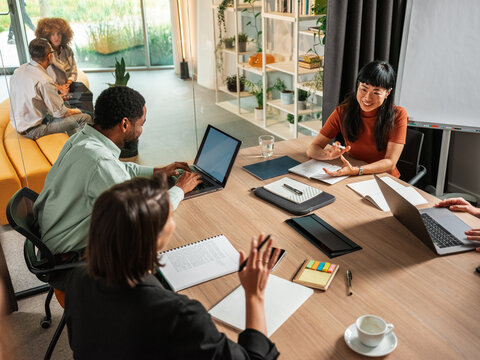 Business Team Meeting In Modern Office With Laptops and Notebooks