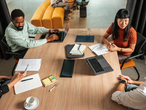 Collaborative Team Meeting In A Modern Office With Laptops